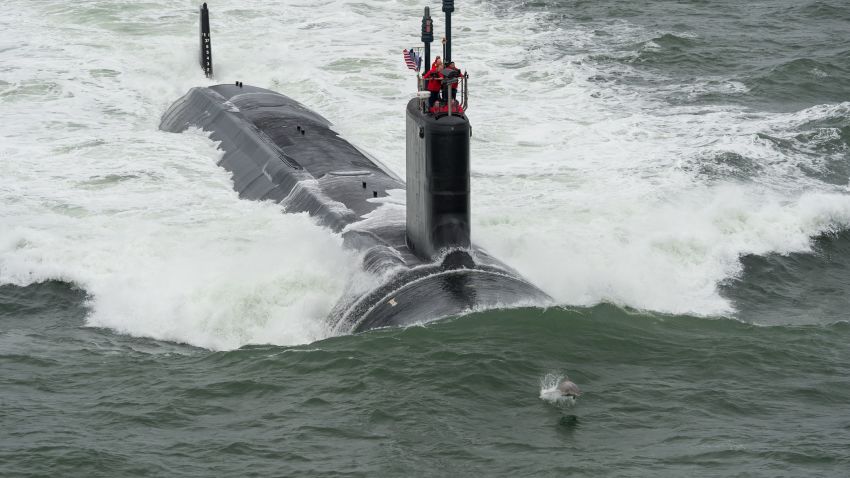 A dolphins swims in front of Navy's newest submarine, the attack submarine USS John Warner, during its sea trials in May. The John Warner was commissioned on Saturday, August 1, in a ceremony in Norfolk, Virginia. Virginia-class attack subs, displacing 7,800 tons and at 377 feet long, "are designed to seek and destroy enemy submarines and surface ships; project power ashore with Tomahawk cruise missiles and Special Operation Forces (SOF); carry out Intelligence, Surveillance, and Reconnaissance (ISR) missions; support battle group operations; and engage in mine warfare, according to the Navy. The Navy has 12 Virginia-class subs in service. Click through the gallery to learn more about the Navy's submarine fleet.