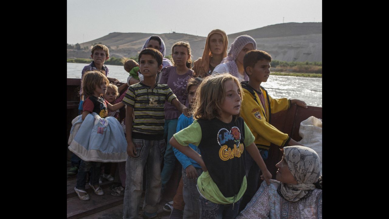 A Syrian family crosses the Tigris river to seek refuge in northern Iraq. "Their sense of uncertainty was really palpable," photographer Ivor Prickett said.