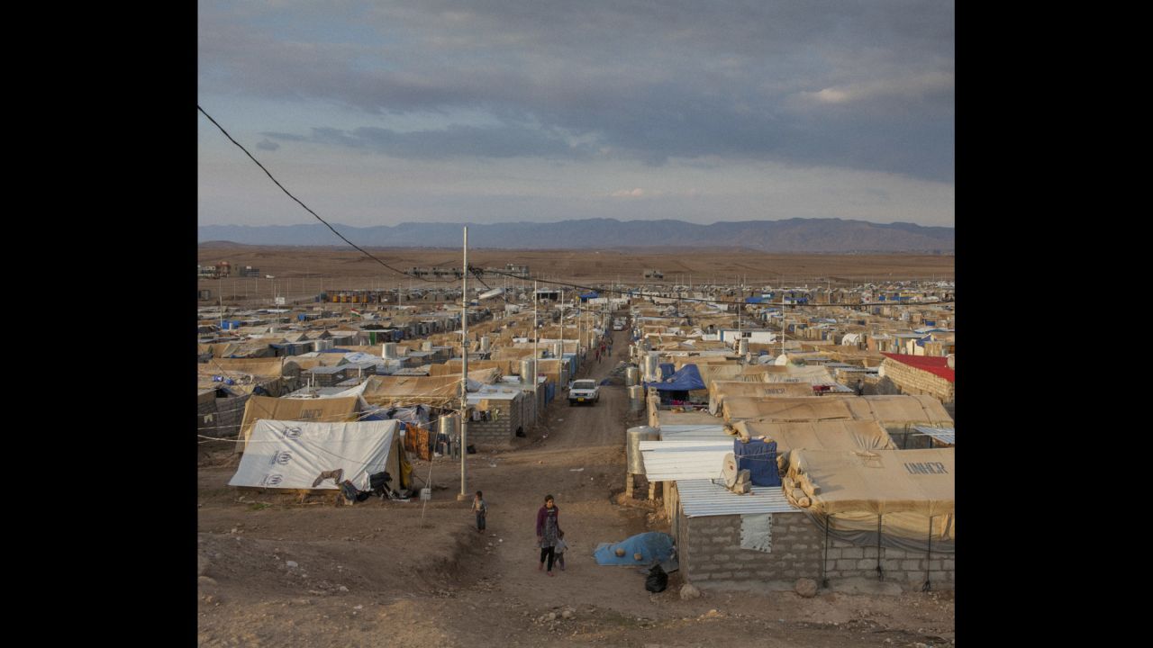 A Syrian woman and her child walk through the Domiz refugee camp in northern Iraq.