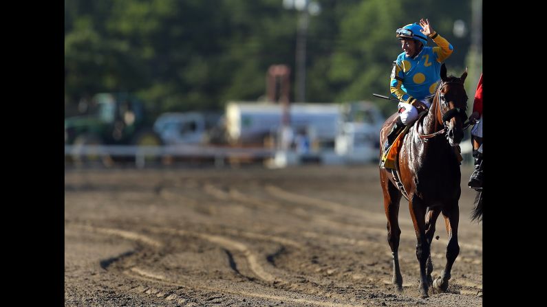 Victor Espinoza, aboard Triple Crown winner American Pharoah, waves after yet another victory -- this one the William Hill Haskell Invitational in Monmouth, New Jersey, on Sunday, August 2. It was Pharoah's eighth straight win.