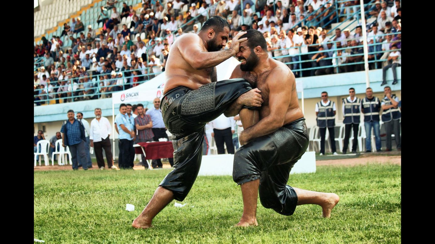 Two men in Ankara, Turkey, compete in an oil-wrestling tournament on Saturday, August 1.