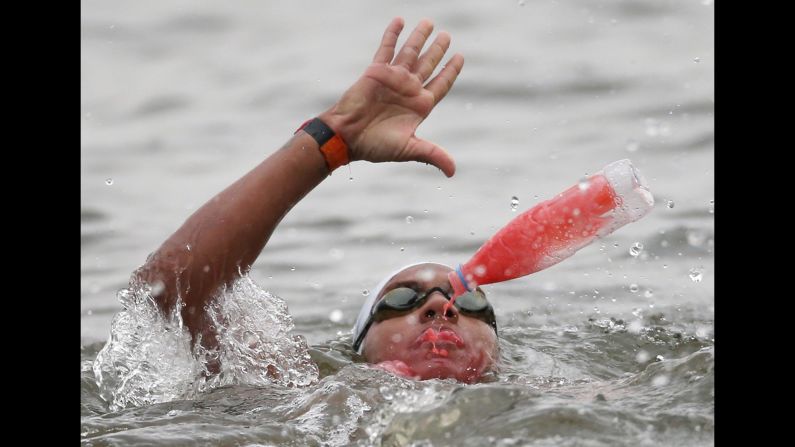 Brazilian swimmer Ana Marcela Cunha takes in what appears to be a sports drink on her way to winning gold in an open-water swimming race Saturday, August 1, at the World Aquatics Championships. She finished the 25-kilometer (15.5-mile) course in five hours, 13 minutes and 47 seconds.