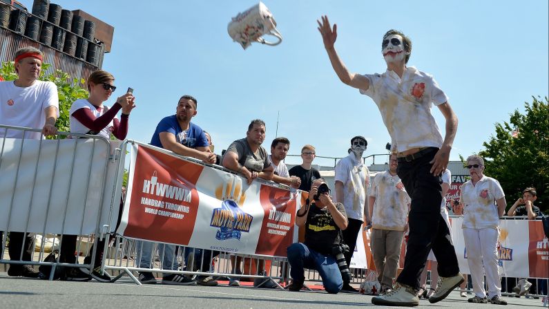 A man wearing Joker-like face paint competes in the World Handbag Throwing Championship, which was held Saturday, August 1, in Bottrop, Germany.