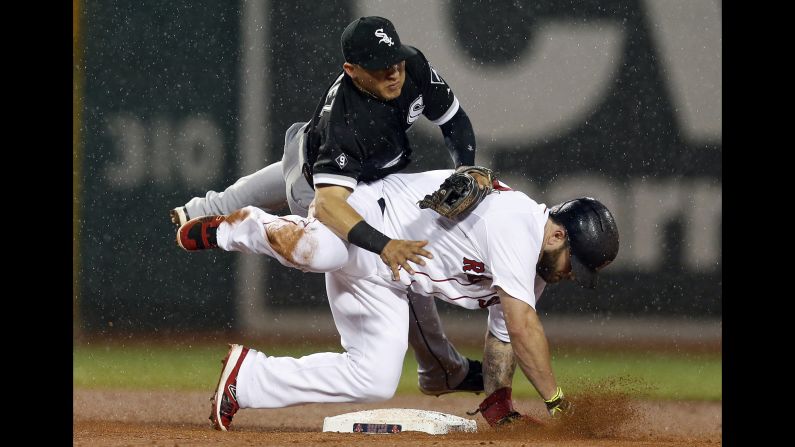 Chicago White Sox infielder Carlos Sanchez falls over Boston's Mike Napoli after a force-out play on Thursday, July 30.