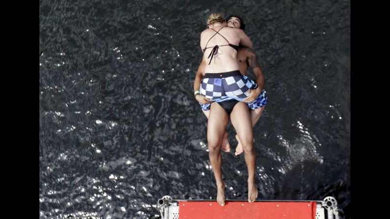 Competitors jump into the water during a cliff-diving competition near Hrimezdice, Czech Republic, on Friday, July 31.