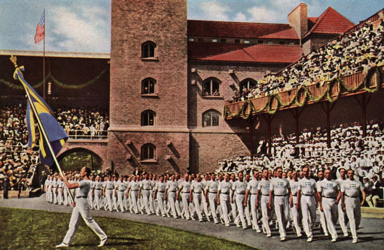 Swedish athletes enter Stockholm's Olympiastadion on June 6, 1912, under the watchful eye of King Gustaf V.  "It is with legitimate joy and pride that we Swedes see athletes from every part of the world gathered here with us," the monarch said upon opening the Games. "It is a great honor for Sweden that Stockholm has been chosen as the scene of the Fifth Olympiad, and I bid all of you, athletes and friends of athletics, a most hearty welcome to this friendly contest of the nations." In an Olympic first, electronic timing was introduced for athletics events.