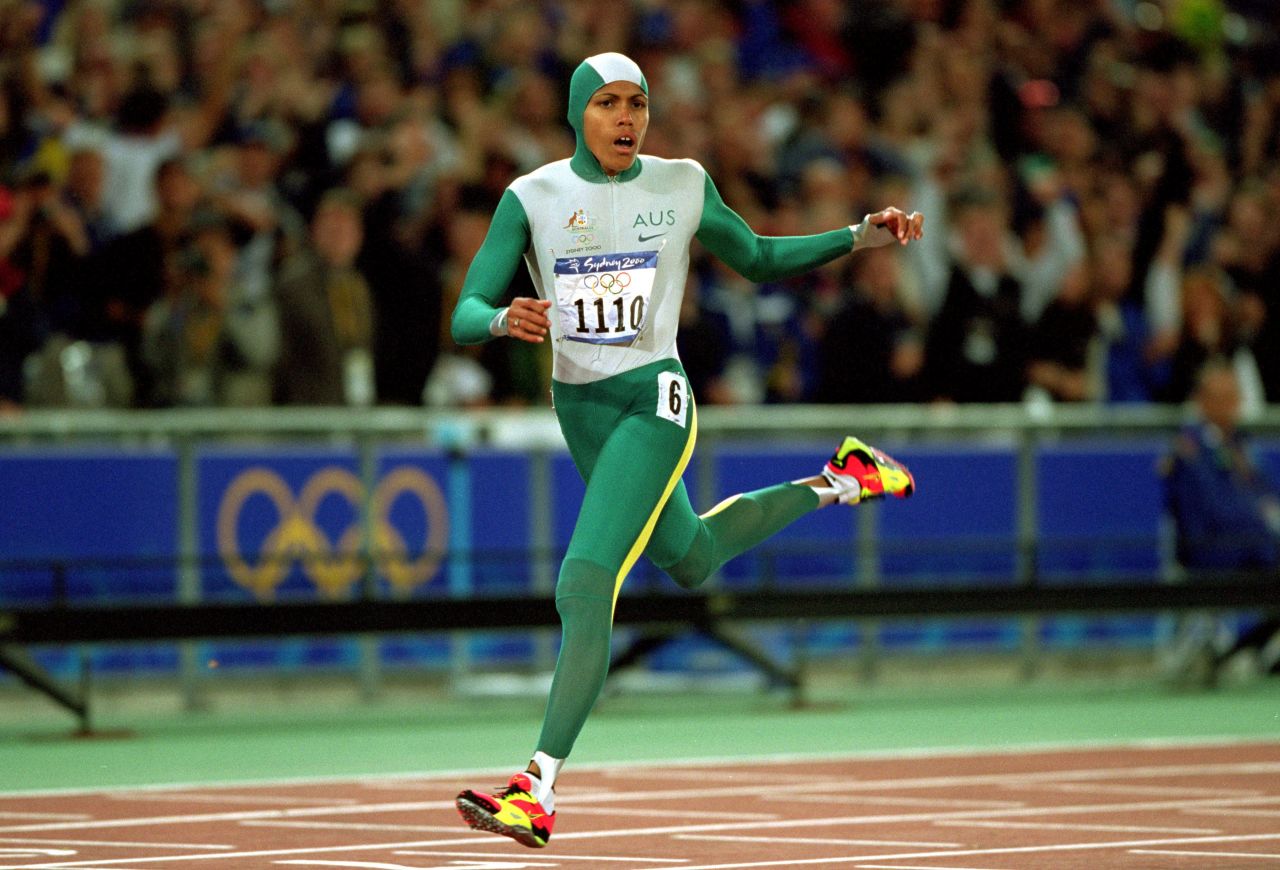 Cathy Freeman delighted Australian fans by winning the women's 400m, becoming the first athlete to light the Olympic torch and take a gold medal at the same Games.