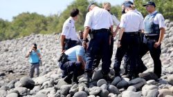 Caption:Police officers inspect metallic debris found on a beach in Saint-Denis on the French Reunion Island in the Indian Ocean on August 2, 2015, close to where a Boeing 777 wing part believed to belong to missing flight MH370 washed up last week. A piece of metal was found on La Reunion island, where a Boeing 777 wing part believed to belong to missing flight MH370 washed up last week, said a source close to the investigation. Investigators on the Indian Ocean island took the debris into evidence as part of their probe into the fate of Malaysia Airlines flight MH370, however nothing indicated the piece of metal came from an airplane, the source said. AFP PHOTO / RICHARD BOUHET (Photo credit should read RICHARD BOUHET/AFP/Getty Images)