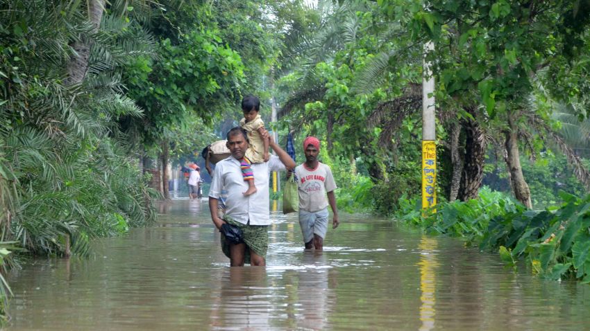 Indian villagers wade through floodwaters in Bherampur Block, Murshidabad. In Gujarat, India's westernmost state, 71 people have died, 69 people have died in West Bengal and 38 have died in Rajasthan according to the State Home Ministry Spokesman Kuldeep Dhatwalia.