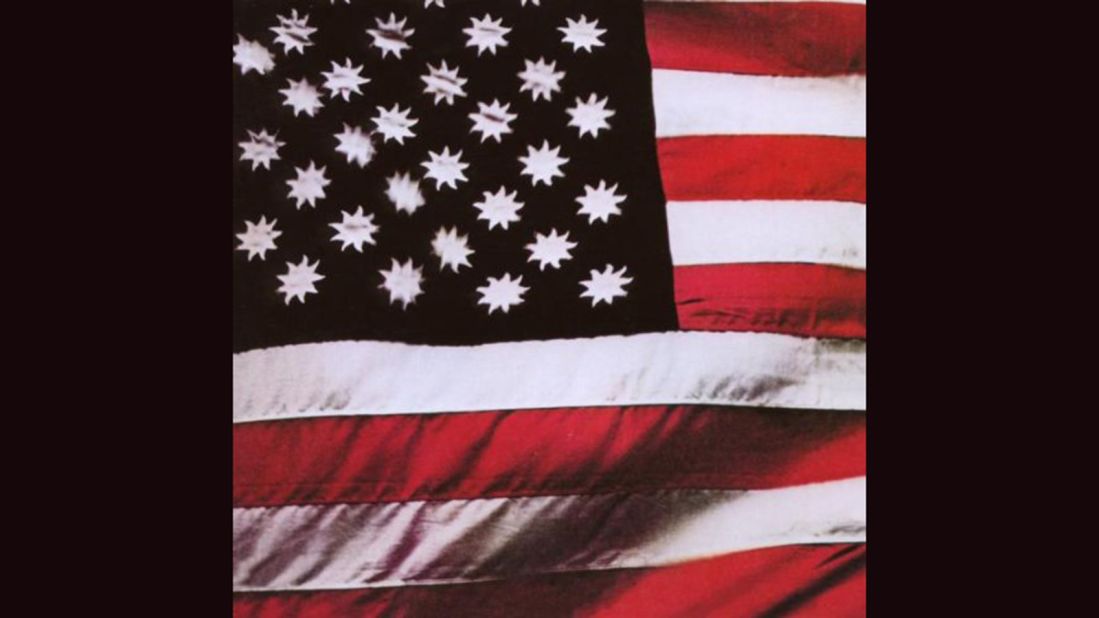 <strong>"There's a Riot Goin' On," Sly and the Family Stone</strong>: Steve Paley's photograph of an American flag with suns in place of stars (on a black field) served as the cover of Sly's 1971 album, but in later years it was replaced by <a href="http://ecx.images-amazon.com/images/I/51jVueymJML._SY300_.jpg" target="_blank" target="_blank">a picture of the band in concert</a>. 