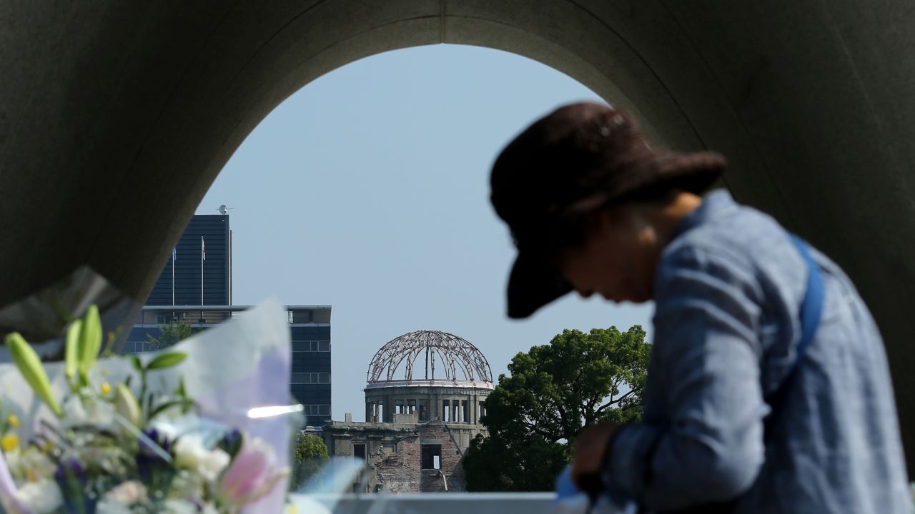 A woman prays Wednesday, August 5, at the Hiroshima memorial park.