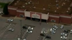 NS Slug: TN:THEATER SHOOTING-SCENE AERIALS  Synopsis: Man who opened fire in TN theater dead.  Video Shows: wide shot of theater, police officers walking around theater, more police cars, more officers walking around   Keywords: