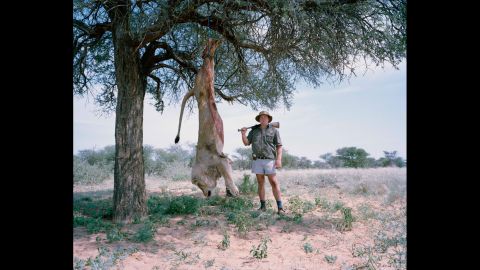 Untitled professional hunter with trophy lion, South Africa.