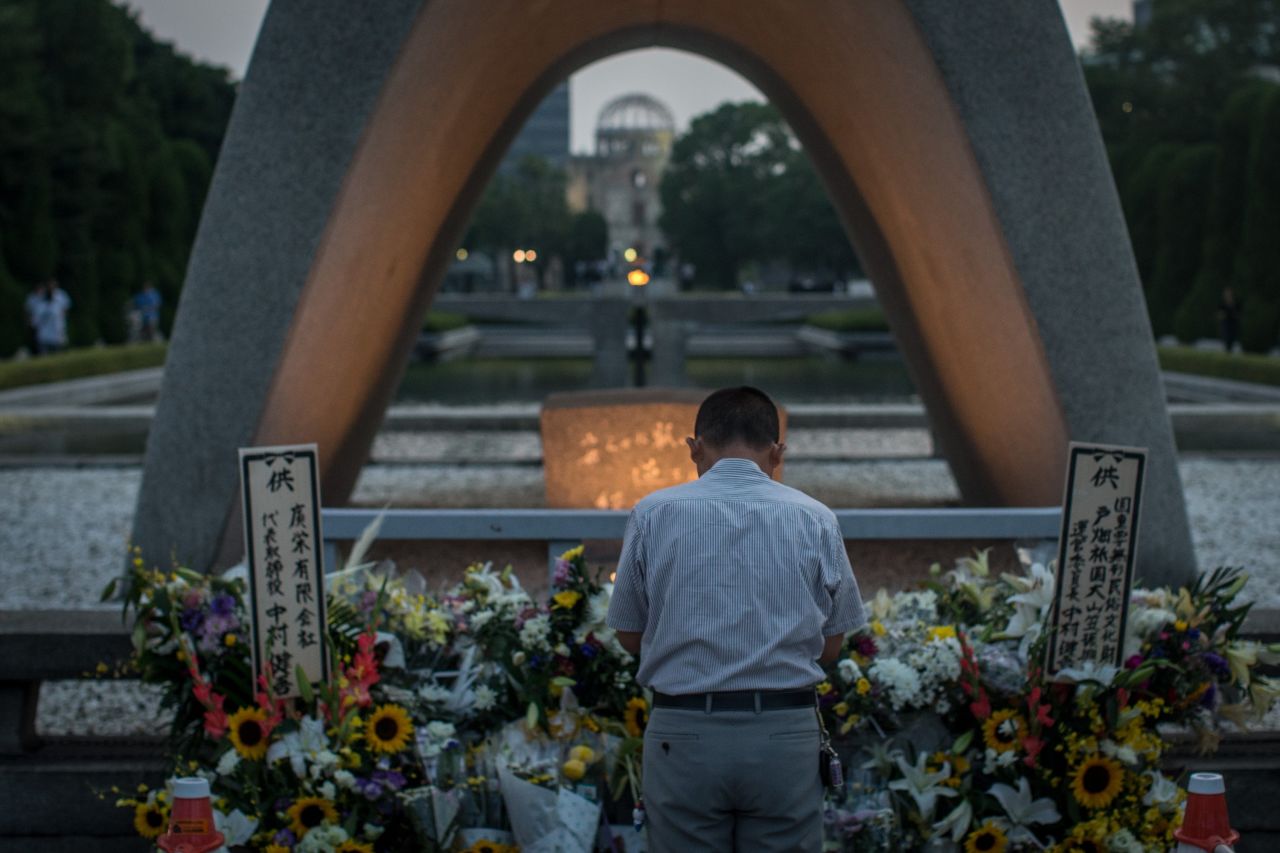A man prays at the memorial on August 6.