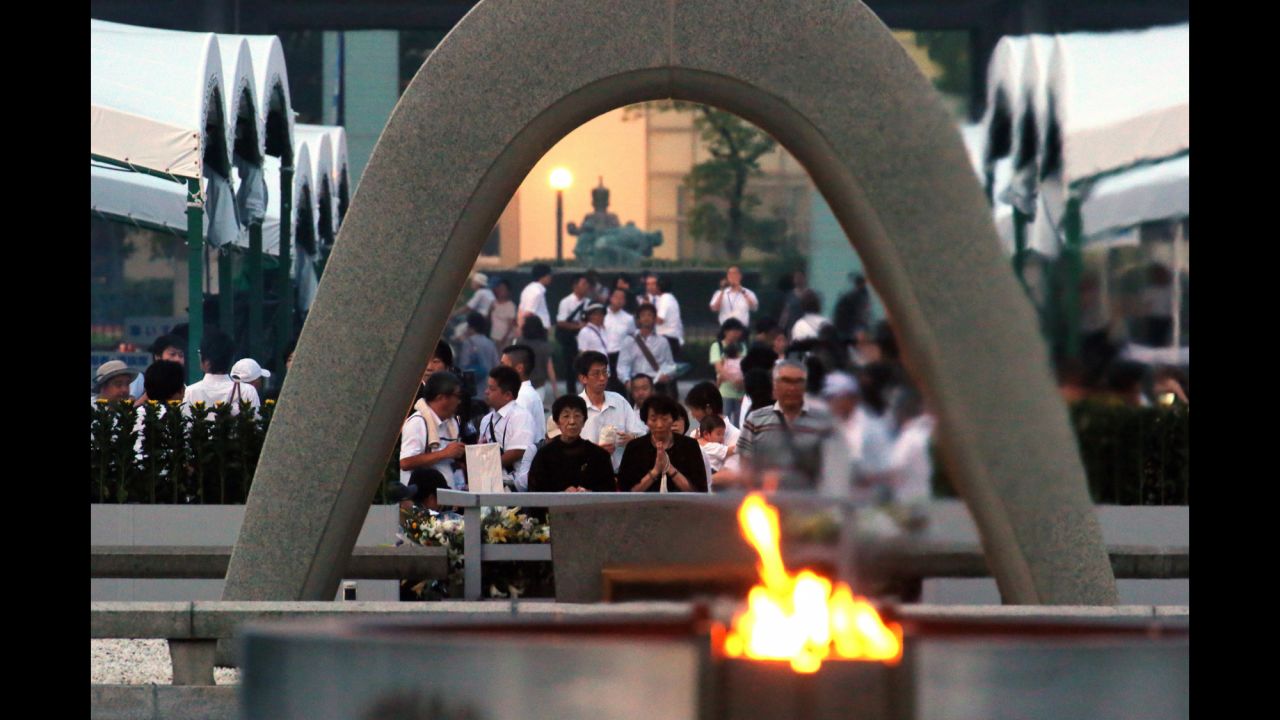 People pray in front of the cenotaph.