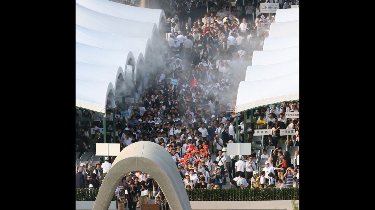 People pray in front of the cenotaph during the memorial ceremony.