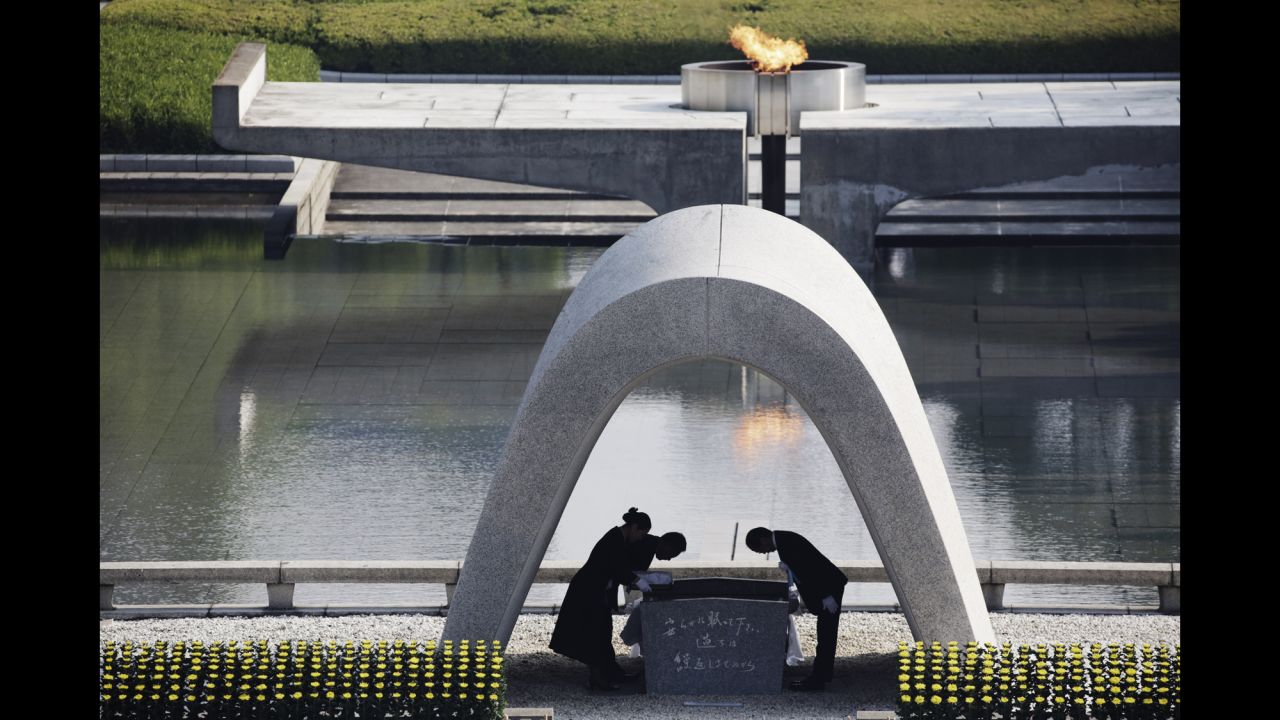 Hiroshima Mayor Kazumi Matsui, right, bows at the Hiroshima Memorial Cenotaph on August 6.