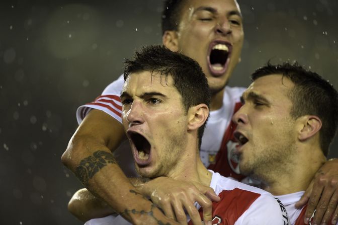 Lucas Alario (left) celebrates after opening the scoring for River on the stroke of half time on a wet night at the Monumental.