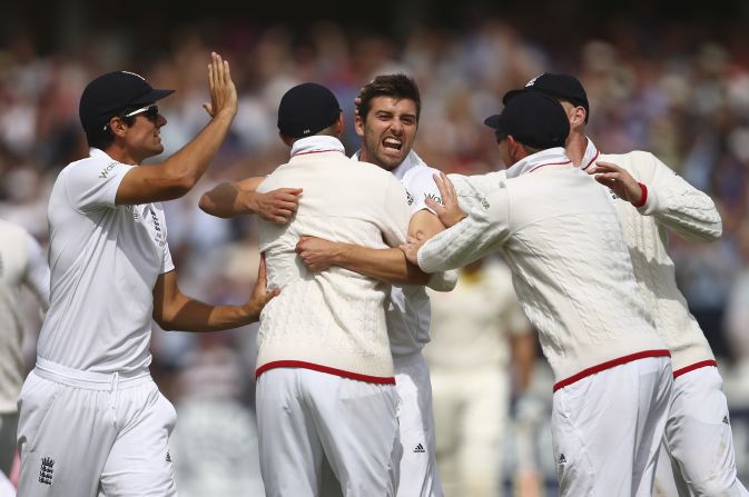 Second out: Mark Wood of England celebrates after taking the wicket of Australia's David Warner.