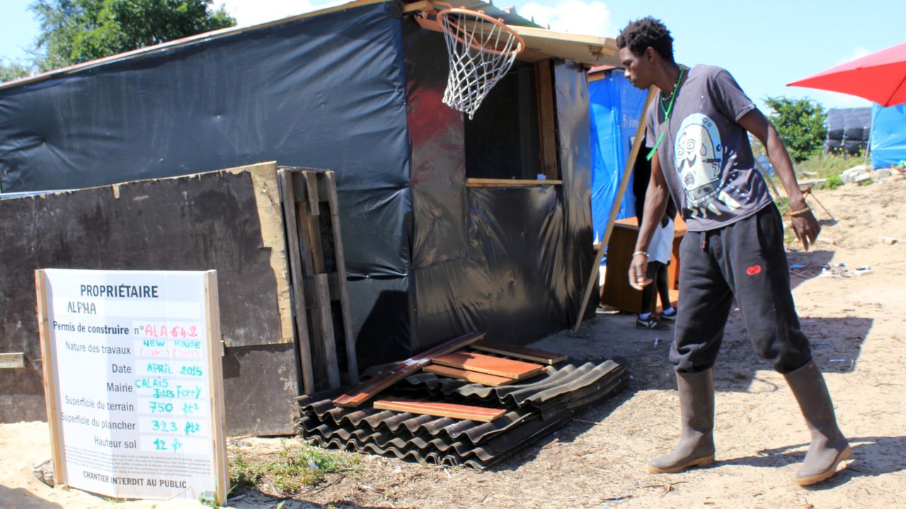 Some local residents, resigned to staying in the camp at least semi-permanently, have taken on jobs. This is Alpha, from north Africa, who has become the local builder. He uses materials donated by local French people.