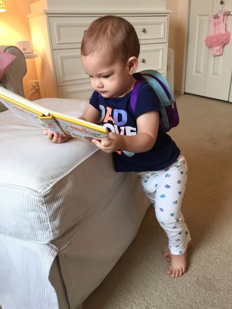 Chicago 1-year-old Juliana can't even walk yet but loves her backpack and books.
