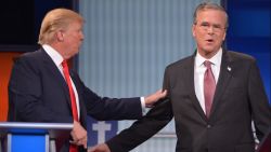 Real estate tycoon Donald Trump, left, and former Florida Gov. Jeb Bush interact during a commercial break of the prime-time Republican presidential debate. The debate was one of two in Cleveland on Thursday, August 6, hosted by Fox News.