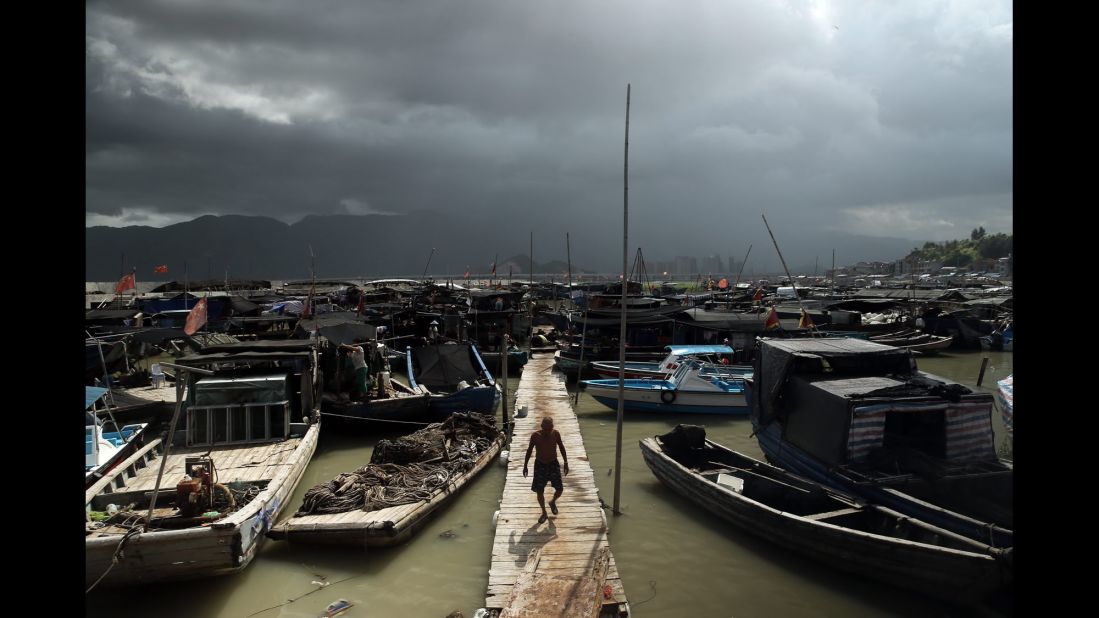 A fisherman walks on a pier in Ningde, China, on Friday, August 7. 
