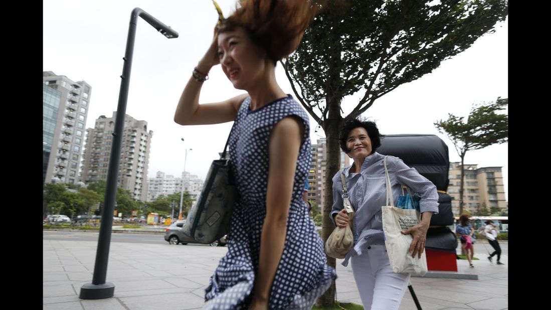 Two women battle the winds from the approaching typhoon in Taipei, Taiwan, on August 7.