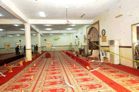 Saudi officials and investigators check the inside of the mosque on August 6.