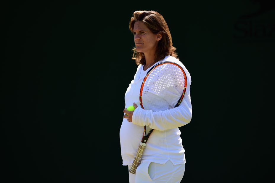 Here a pregnant Mauresmo looks on during a practice session for Murray at Wimbledon in July.