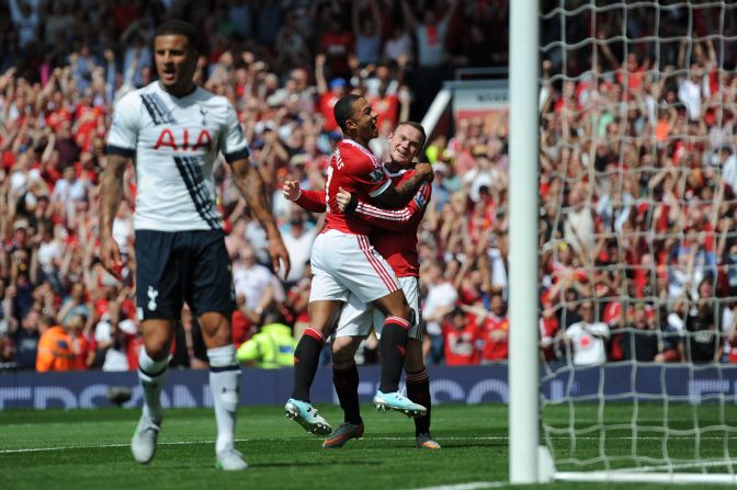 Manchester United's Dutch midfielder Memphis Depay (2nd R) celebrates with Wayne Rooney (R) after United take the lead due to an own goal from Tottenham Hotspur defender Kyle Walker during the English Premier League football match between Manchester United and Tottenham Hotspur at Old Trafford in Manchester.