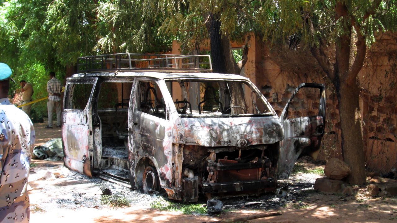 A burned vehicle sits in front of the Hotel Byblos in the Sevare, Mali, after gunmen stormed the hotel on Friday, August 7.