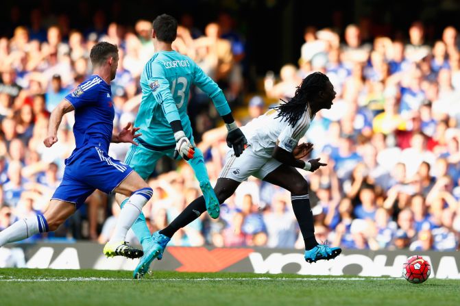 Bafetimbi Gomis of Swansea City is brought down by Thibaut Courtois of Chelsea, resulting in a red card and penalty during the Premier League match between Chelsea and Swansea City at Stamford Bridge on the opening weekend of the 2015-2016 campaign.