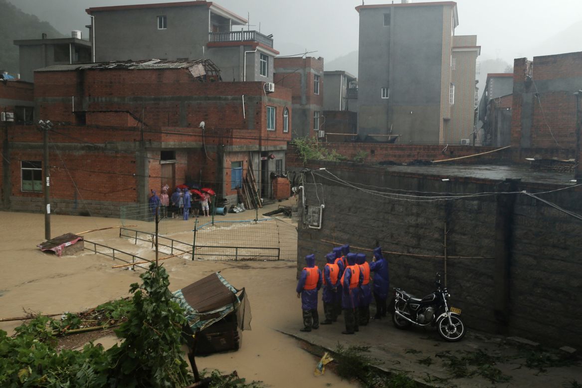 Rescuers stand by a flooded area in Ningde, China, on August 9. 