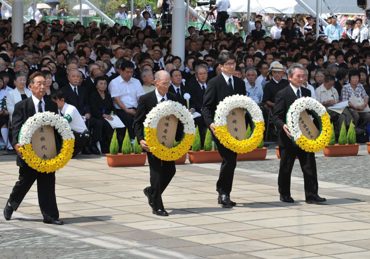 Nagasaki Mayor Tomihisa Taue, second right,  and other representatives offer wreaths of flowers during the memorial ceremony.