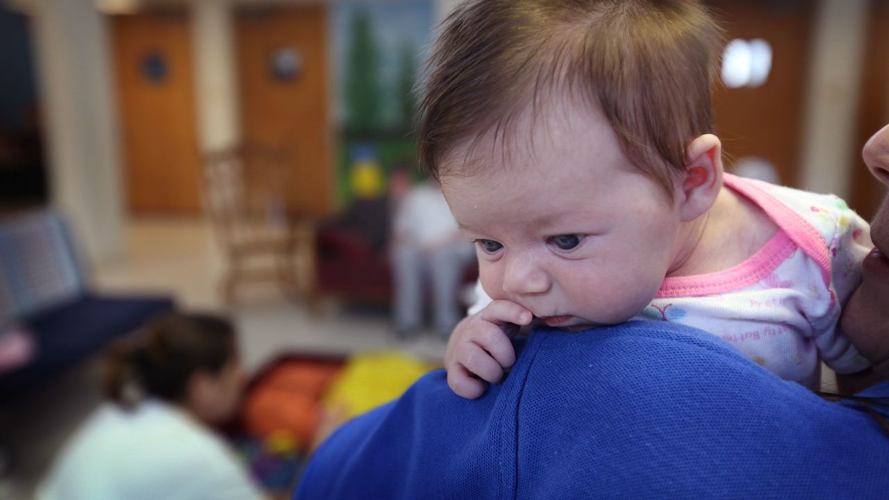 DECATUR, IL - FEBRUARY 18:  Gayle Bush, an inmate serving a 42-month sentence for DUI, holds six-week-old Lillian, the child of another inmate in the common area of her ward at Decatur Correctional Center February 18, 2011 in Decatur, Illinois. Bush works as a child caregiver at the facility, helping mothers with their children. Lillian, who was born while her mother was serving a two-year sentence for theft, lives with her mother at the prison, part of the Moms with Babies program at the minimum security facility. The program allows incarcerated women to keep their newborn babies with them for up to two years while serving their sentence. The program boasts a zero percent recidivism rate compared to the statewide rate of 51.3 percent.  (Photo by Scott Olson/Getty Images)