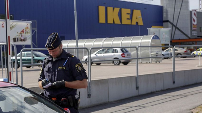 A police office talks to customers outside the Ikea store in Vasteras, Sweden, Monday Aug. 10, 2015, after three people were injured in a knife attack at the store. (Peter Kruger/TT via AP) SWEDEN OUT