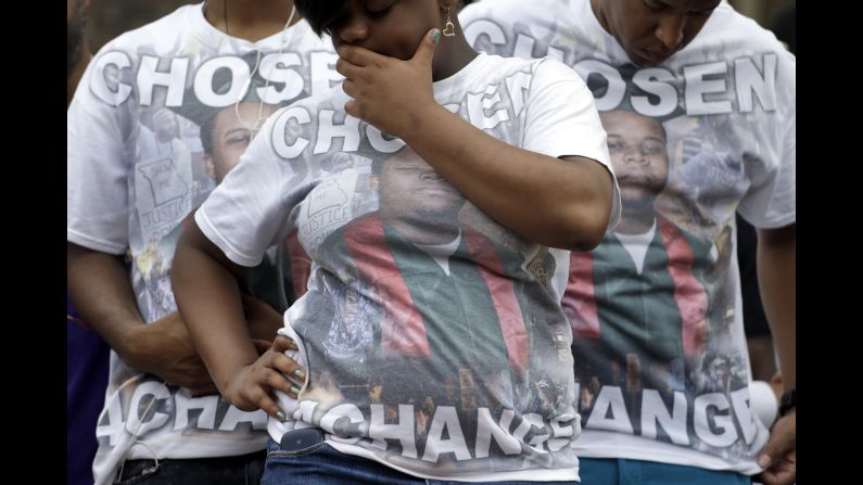 Brown supporters wear T-shirts with the late teen's picture and the message "Chosen 4 Change" on August 9 as they take part in the remembrance ceremony in Ferguson.