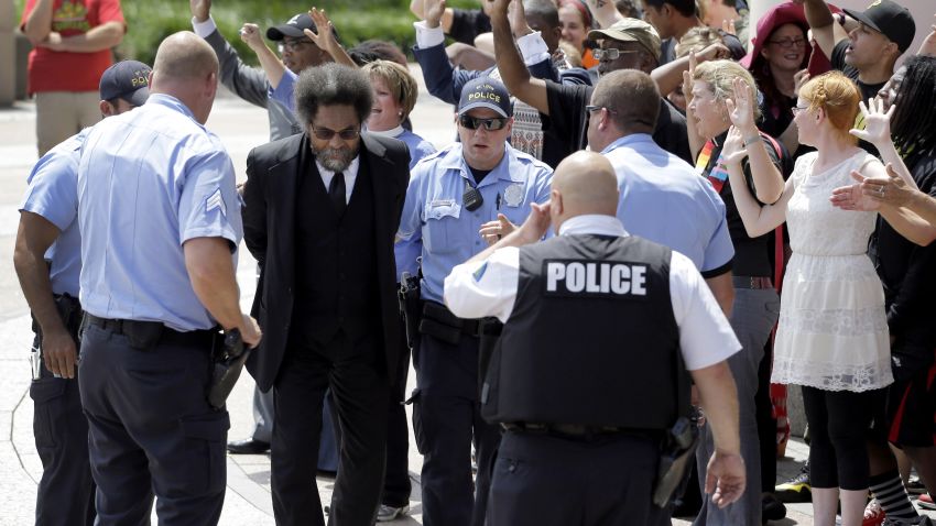 Cornel West is arrested by St. Louis Police during a protest outside the Thomas F. Eagleton Federal Courthouse, Monday, Aug. 10, 2015, in St. Louis. The arrests of scholar and civil rights activist West and the few dozen others were part of what's been billed as a national day of civil disobedience. (AP Photo/Jeff Roberson)