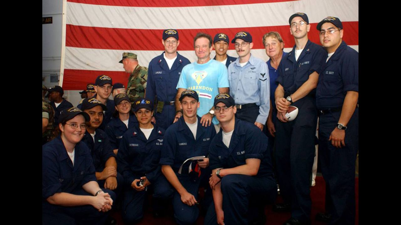 <a href="http://ireport.cnn.com/docs/DOC-1161067">Aurora Contreras</a> of the U.S. Navy says meeting Robin Williams aboard the USS Harry S. Truman was one of her fondest memories from her 2004 deployment in the Persian Gulf. Contreras is shown kneeling to the left of the soldier whom Williams was standing behind. "To see him there was a major highlight of our time onboard," she said.