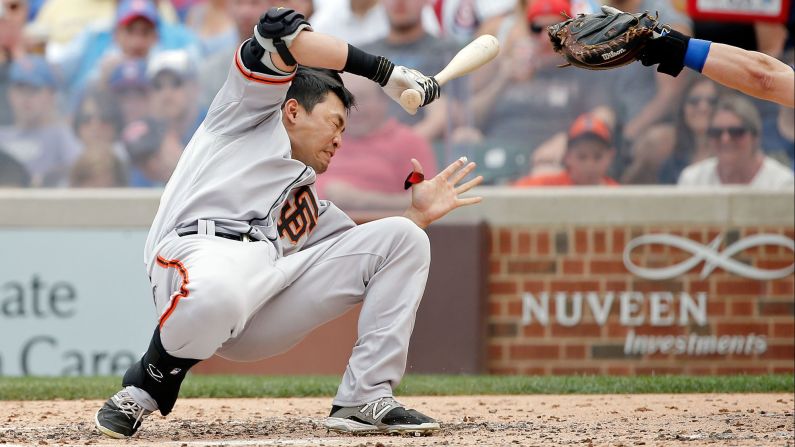 Nori Aoki of the San Francisco Giants reacts after being hit in the head by a pitch thrown by Chicago Cubs pitcher Jake Arrieta at Wrigley Field on Sunday, August 9, in Chicago.
