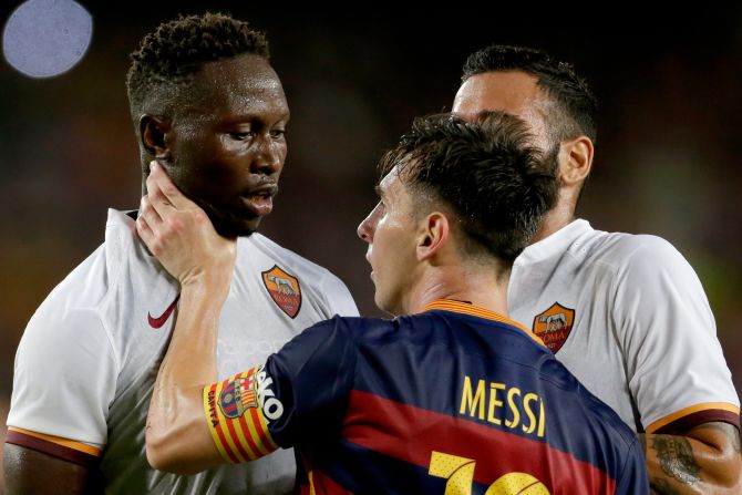 Lionel Messi of FC Barcelona grabs AS Roma defender Mapou Yanga-Mbiwa by the throat during the Joan Gamper Trophy match on Wednesday, August 5, in Barcelona. 