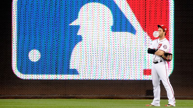 Bryce Harper of the Washington Nationals blows a bubble while a play is reviewed in the third inning against the Arizona Diamondbacks on Wednesday, August 5, in Washington.  