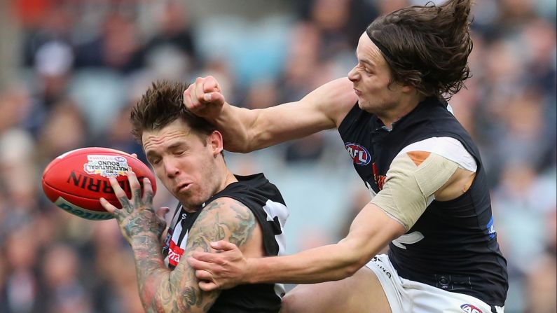 Dane Swan of the Magpies marks in front of Dylan Buckley of the Blues as he attempts to spoil during the round 19 Australian Football League match on Saturday, August 8, in Melbourne, Australia.