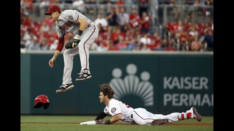 Arizona Diamondbacks shortstop Nick Ahmed jumps in an attempt to field the throw to second from the during the first inning of a baseball game on Tuesday, August 4, in Washington. 