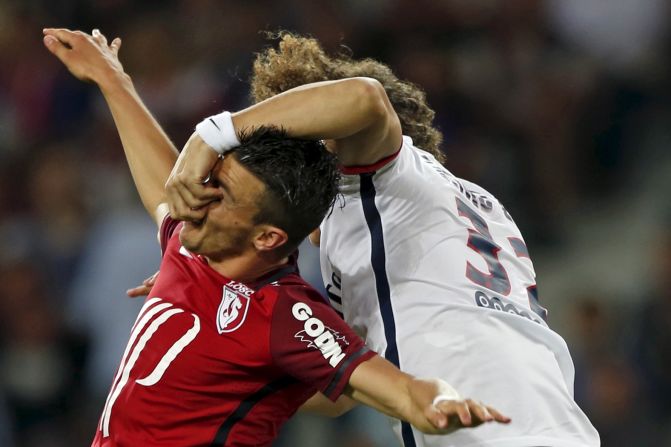 David Luiz, right, of Paris Saint-Germain fights for the ball with Lille's Sebastien Corchia during their French Ligue 1 soccer match in Villeneuve d'Ascq, France, on Friday, August 7. <a href="index.php?page=&url=http%3A%2F%2Fwww.cnn.com%2F2015%2F08%2F04%2Fsport%2Fgallery%2Fwhat-a-shot-sports-0804%2Findex.html">See 40 amazing sports photos from last week</a>