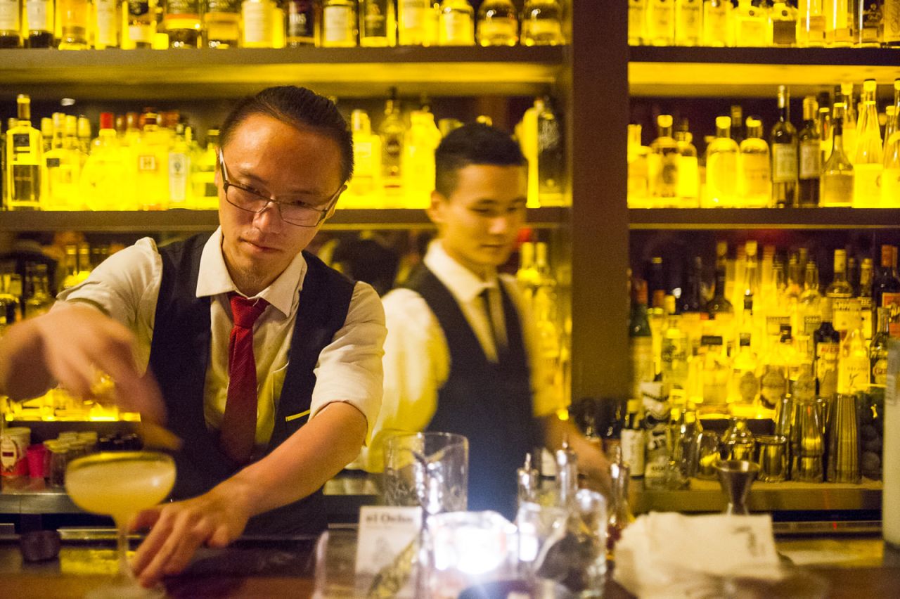 Hiker Yao, (left) bartender at El Ocho, prepares a Corpse of Old Tom, one of the venue's signature cocktails. 