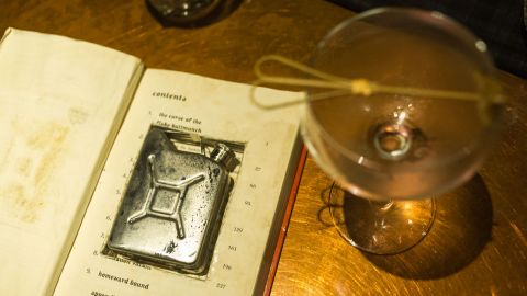 "Robin Hood Roy," a signature cocktail at Flask, comes in a petrol-can-shaped flask hidden inside a book.