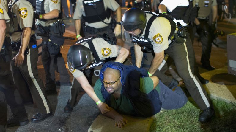 A demonstrator is arrested in Ferguson on August 10.