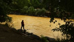 Kalyn Green, resident of Durango, stands on the edge of the river August 6, 2015 along Animas River. "I come down to the river every morning before work." said Green. "The river in a sense of calm for me." Over a million gallons of mine wastewater has made it's way into the Animas River closing the river and put the city of Durango on alert.